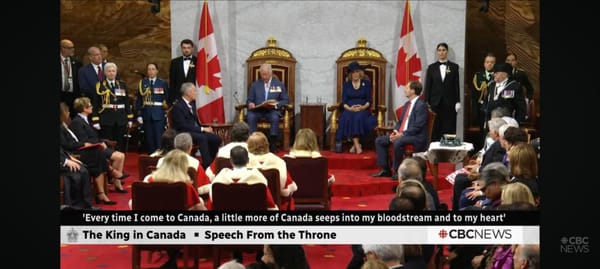 His royal highness, king of Canada, sitting on a literal throne above the supreme court justices looking like santa clause in the Senate of Canad